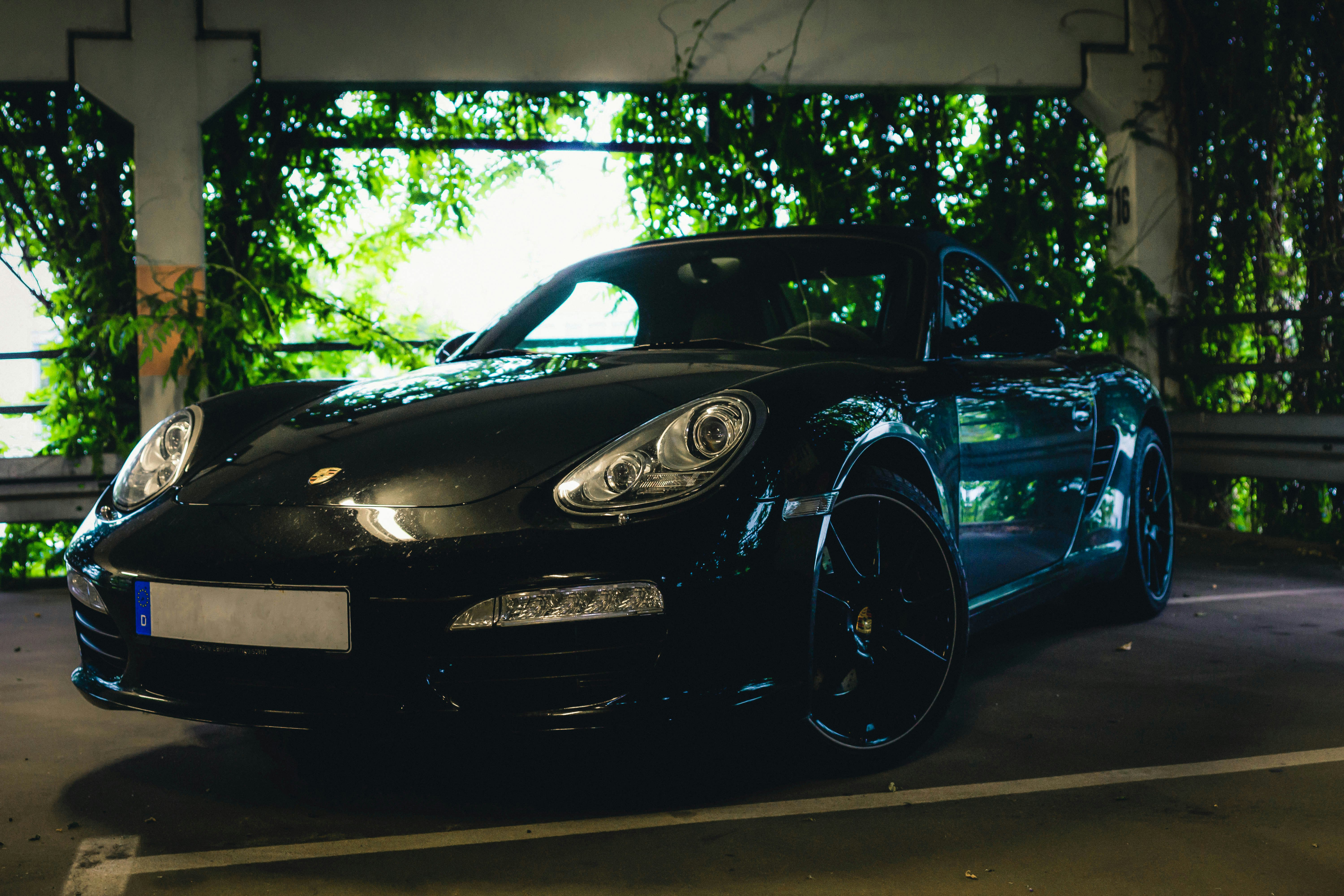 black porsche 911 parked on parking lot during daytime